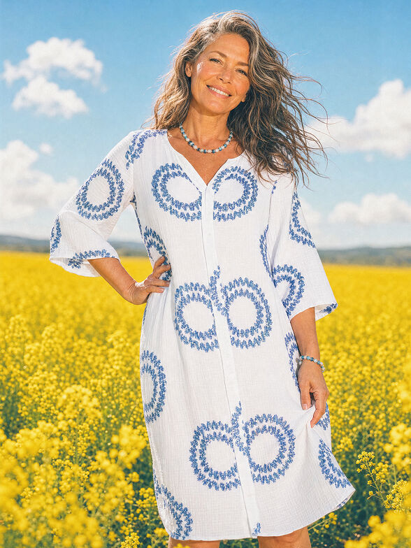 white and blue print midi dress in canola field 