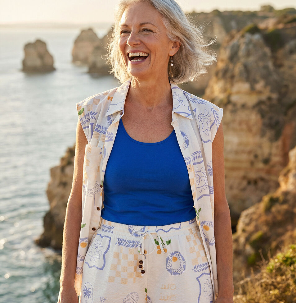 Woman on cliff with wind in her hair. Printed matching top and short set.